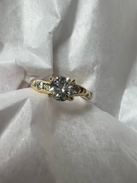 A very special custom made piece.
Anastasia came to me with her grandmother’s ring, asking me to give it a new life as it became her own engagement ring.
The idea was to preserve the diamonds that held meaning, while completely reimagining their setting.
I created a new silhouette in 18ct yellow gold, centred around a 1.5ct diamond and framed by ten smaller diamonds along the sides.
A piece made to honour what was, and become something entirely its own. 🤍
